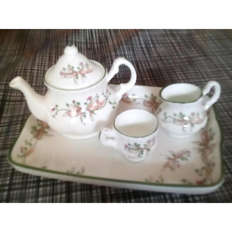 Porcelain set of bowls made in 1792. A porcelain tea set and tray, and bull China bells