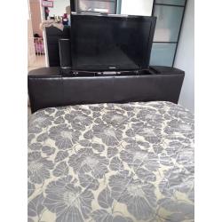 Very dark brown/black tv bed