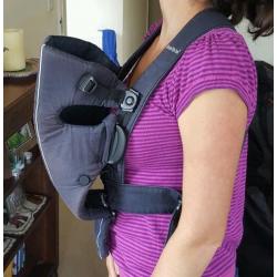 Baby Bjorn infant carrier with cold-weather hoodie.