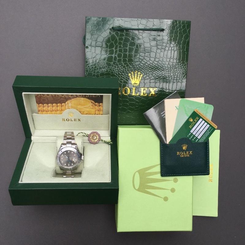 Silver Rolex YatchMaster with silver face and blue hand in Rolex bag and box