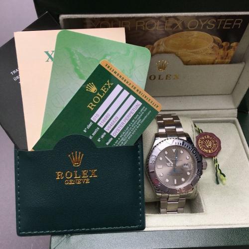 Silver Rolex YatchMaster with silver face and blue hand in Rolex bag and box