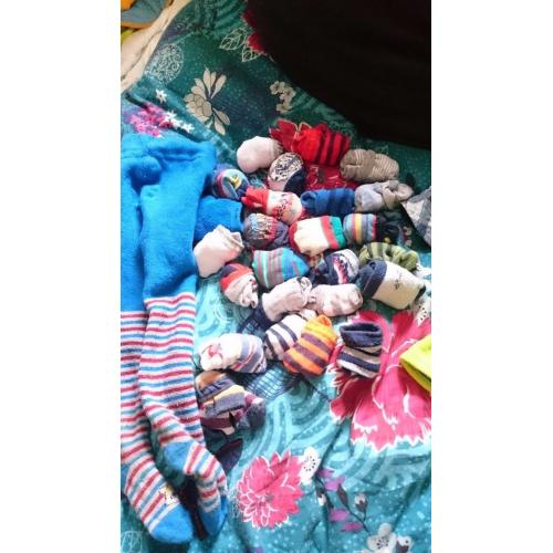 25 pairs of baby socks and a pair of stockings