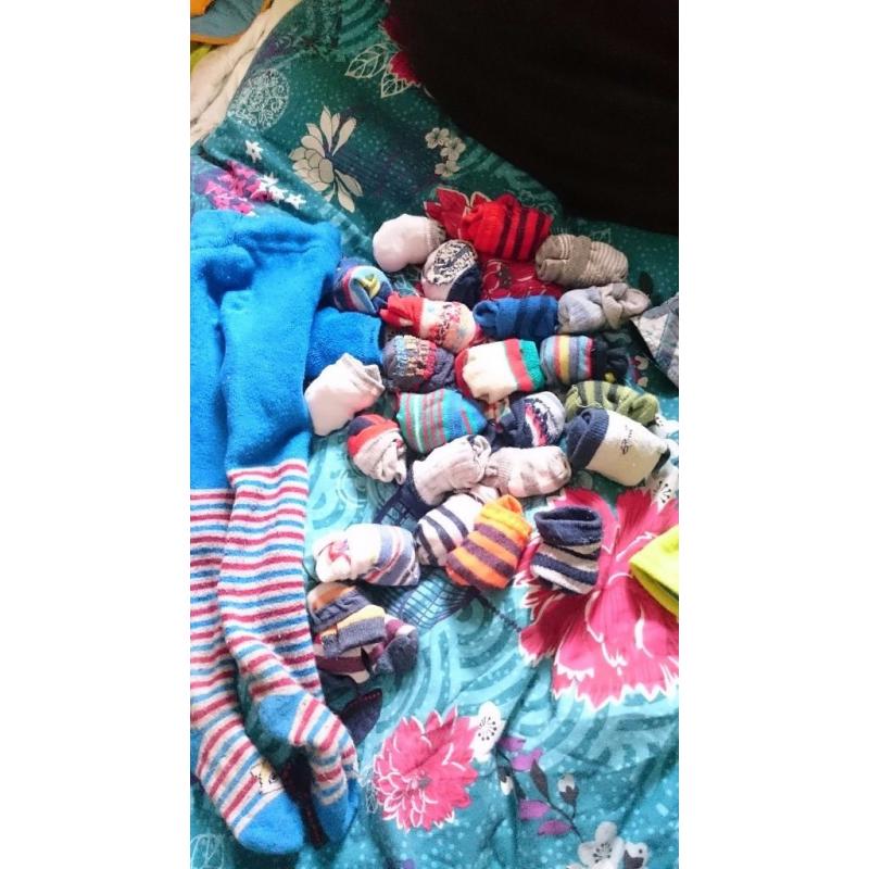 25 pairs of baby socks and a pair of stockings