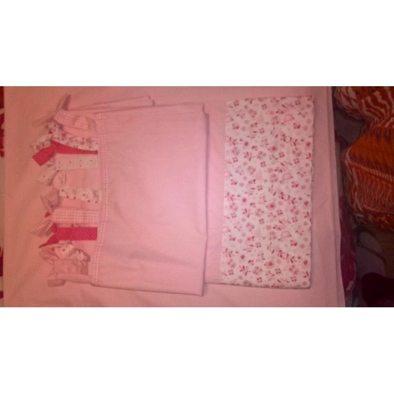 pink curtains with cute bow ties on top and pink detailing on the bottom