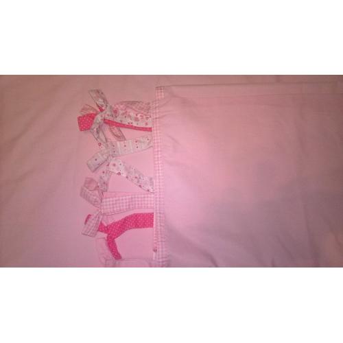 pink curtains with cute bow ties on top and pink detailing on the bottom