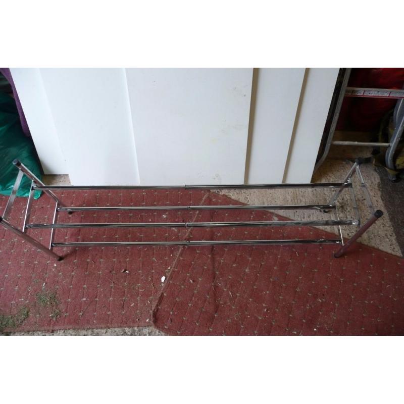 silver metal extending shoe rack.