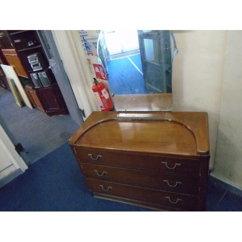 vintage dresser with unusual shaped mirror.