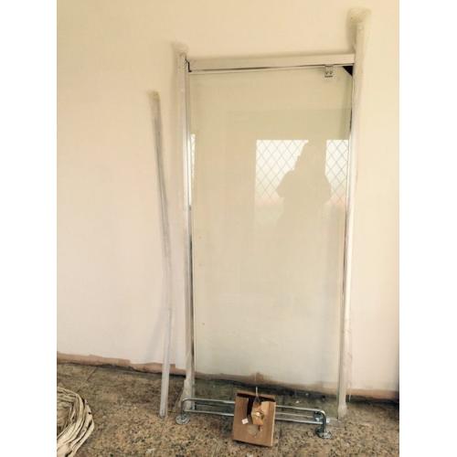 Walk in shower glass panel and rail.
