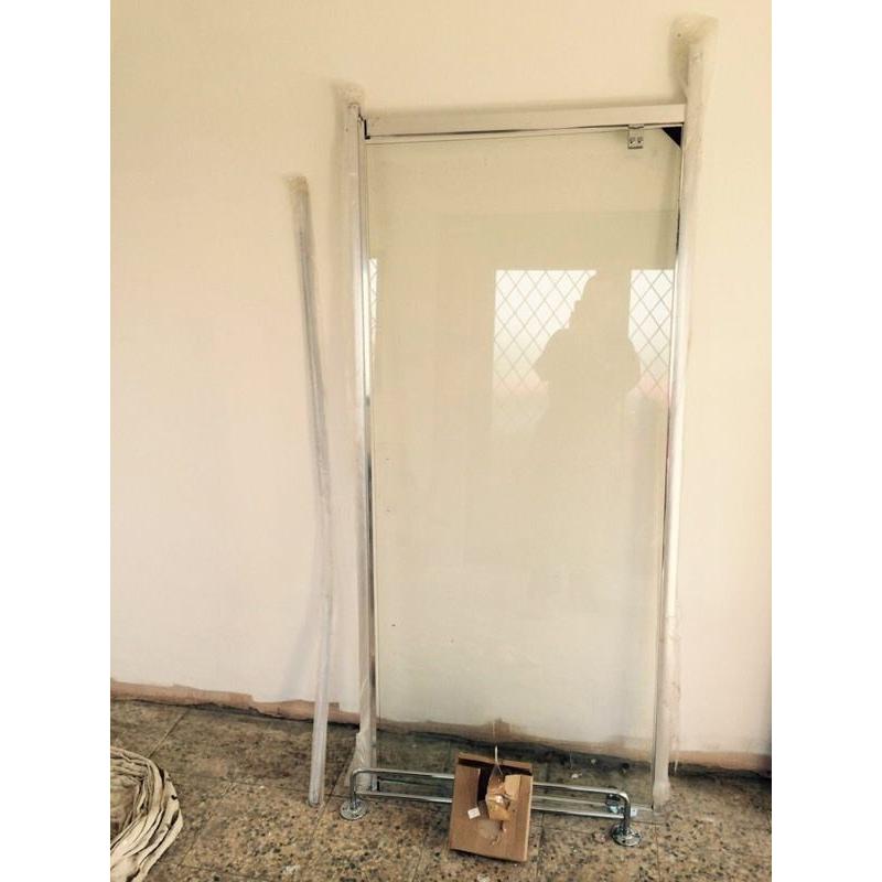 Walk in shower glass panel and rail.