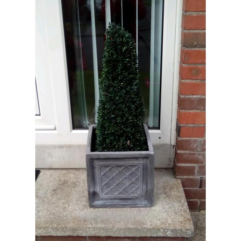 Artificial pyramid shaped tree in pot