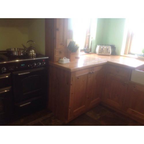 Solid wood Pineland kitchen units, Maple worksurface, French double bowl sink with mixer taps.