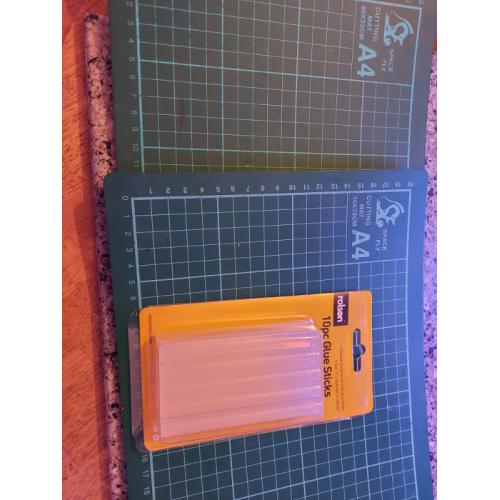 Two a4 cratt cutting mats and glue sticks