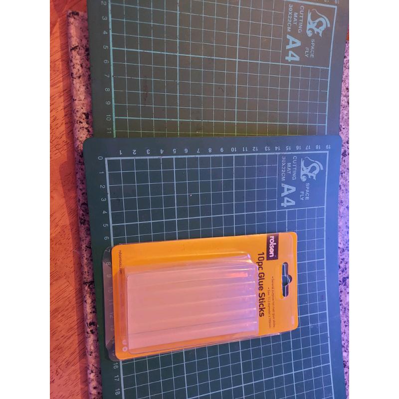 Two a4 cratt cutting mats and glue sticks