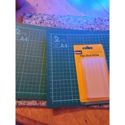 Two a4 cratt cutting mats and glue sticks