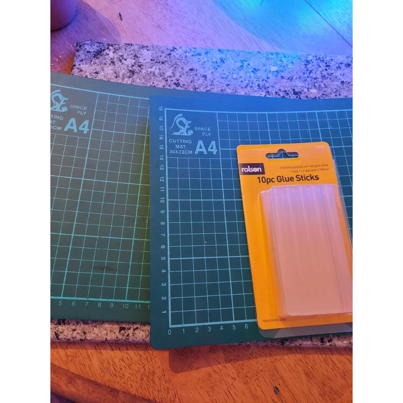Two a4 cratt cutting mats and glue sticks